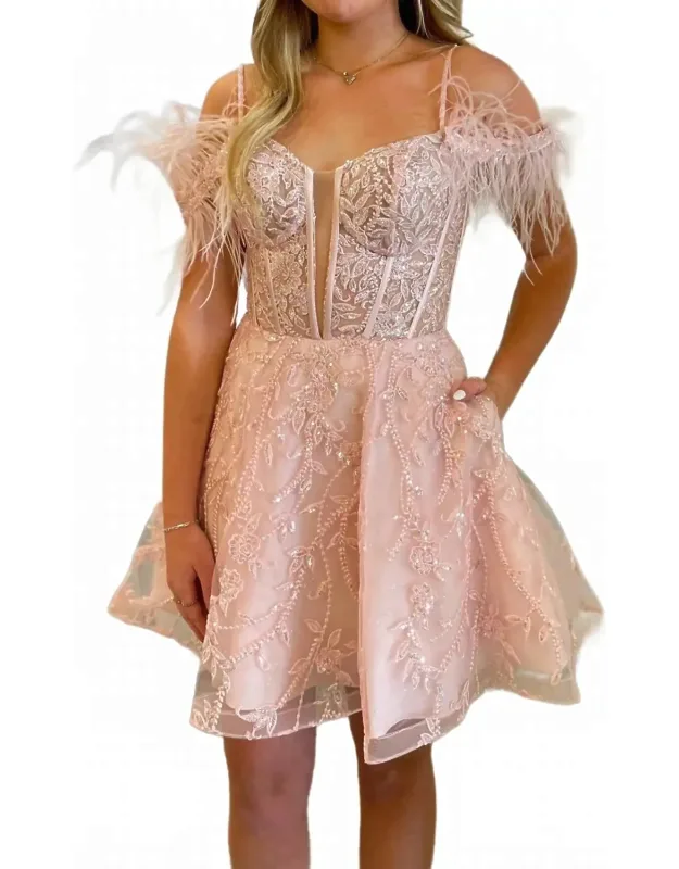 Sheer Corset Top With Feathered Sleeves And A Short Gown.